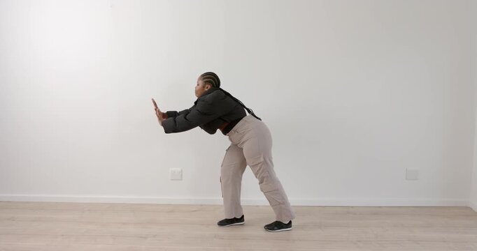 High speed photography for dynamic scenes, Woman in casual clothing performing dance move in empty r