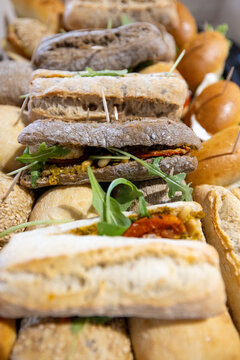 Assorted Gourmet Ciabatta Sandwiches with Pesto, Sun Dried Tomato and Arugula on Catering Platter for Wedding Reception