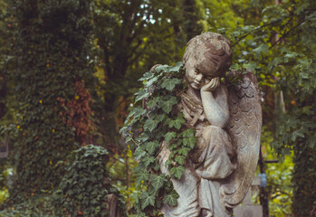 Fototapeta premium Ancient European cemetery with stone angels and historic tombstones