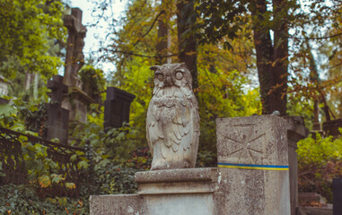 Fototapeta premium Ancient European cemetery with stone angels and historic tombstones