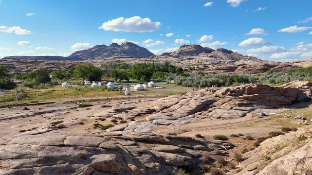 Traditional yurt camp among granite rocks, 4K drone footage, Kazakhstan 