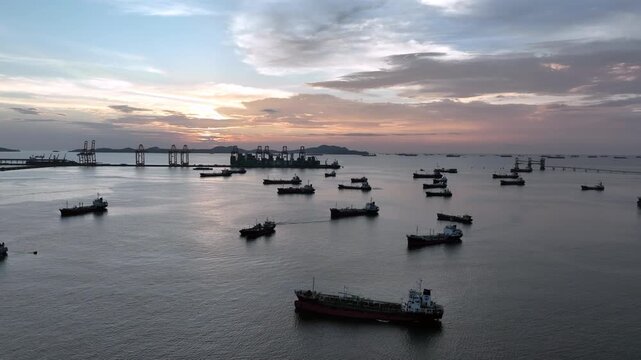 Aerial view oil and gas tanker ship offshore parking in sea, Crude oil tanker ship and LPG tanker ship offshore in bay at sunset, Silhouette oil and gas tanker ship.