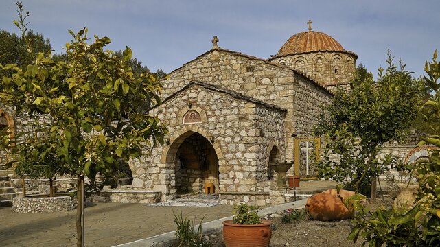 Church with stone fa&ccedil;ade and garden with planters in the foreground, monastery, Moni Thari, near Gadouras reservoir, lonely mountain region, Rhodes, Dodecanese, Greek Islands, Greece