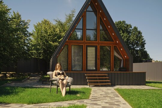 A woman enjoying the tranquility of a sunny day, surrounded by lush greenery and the architectural beauty of a modern a-frame house with large windows