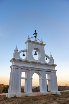 Bell tower of the chapel Ermita Reina de los &Aacute;ngeles, at sunset, Al&aacute;jar, Huelva, Spain