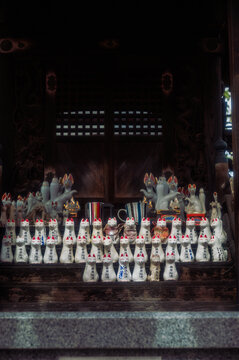 Kitsune (fox) figurines left as offerings at an Inari shrine.