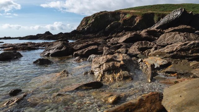 Timelapse of tide going out in a rocky Cornish cove. Coombe Beach near Fowey, Cornwall UK