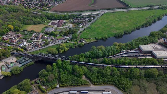 Freight Train Crossing Steel Railway Bridge at Ferrybridge Drone View UK