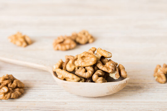 Fresh healthy walnuts in bowl on colored table background. Top view Healthy eating bertholletia concept. Super foods