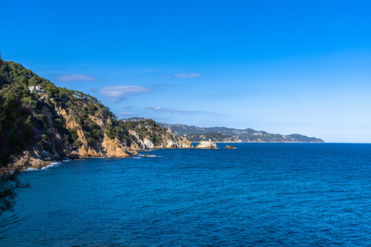 Stunning view of Mediterranean Balearic sea from the coastline path near Blanes at Brava coast towards Lloret de Mar in summer on sunny day, Selva, Girona Catalonia, Spain