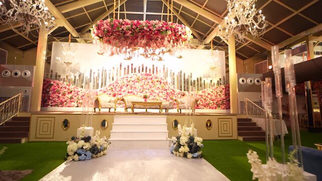 Decorated wedding stage with floral arrangements in a banquet hall in Delhi