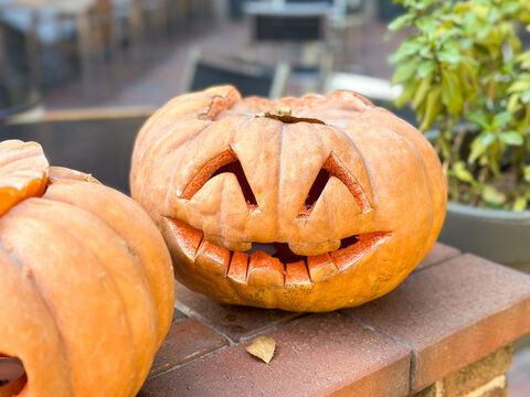 Carved pumpkin with wide grinning mouth and sharp jagged teeth, close-up view
