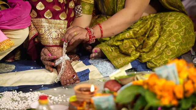 Indian bride wearing silver anklets during a traditional wedding ritual in Delhi