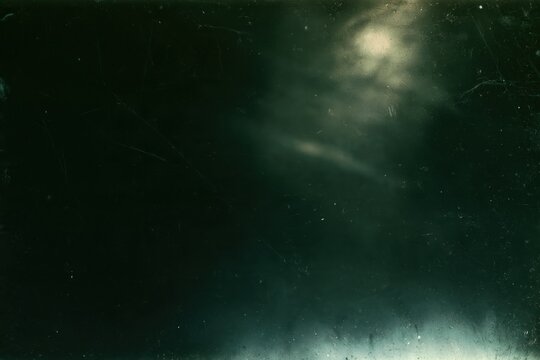 Dark green vintage film texture with hazy light leaks, dust particles, grain and scratches for distressed analog cinema background and retro photo overlay