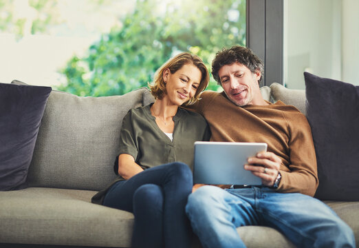 Relax, streaming and tablet with couple on sofa in living room of home for subscription signup. App, download and search with mature people in apartment together for online membership options