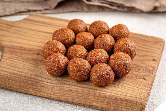 Appetizing traditional kazakh brown irimshik sweet cheese balls neatly arranged on rustic wooden serving board