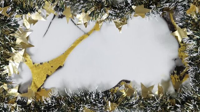 Christmas Garland Frame With Golden Star Confetti and Bokeh Lights Surrounding Blank Message Space