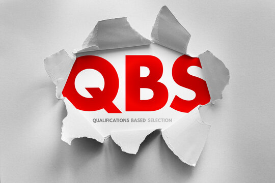 QBS stands for qualifications based selection. Text shown under a torn paper surface. Selection process concept for engineering, architectural, or professional services based on expertise