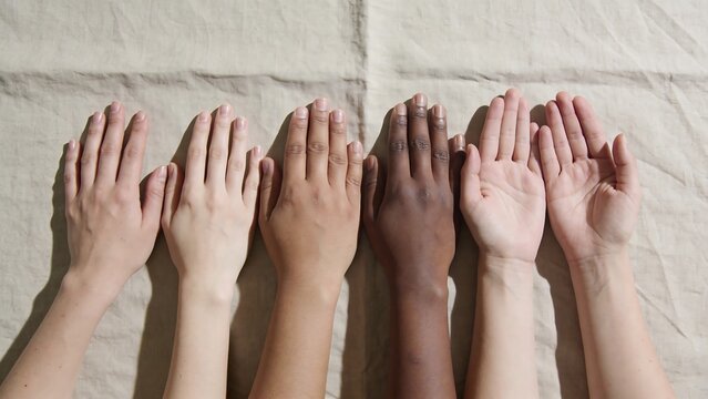 Diverse Human Hands Arranged in a Row on Linen Background