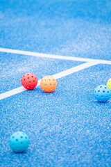 Vertical view of pickleball equipment on blue turf The Concept of game tournament © VicVaz
