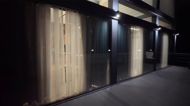Motorized drapes open at dawn and close at dusk in a country estate, smart home convenience, warm interior, candid authentic life captured in real time at home.