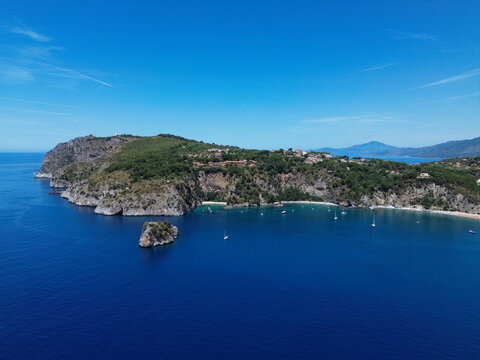 Rocky coastline of Buon Dormire Bay in Palinuro overlooking Coniglio Rock, spectacular Mediterranean seascape in Cilento, Campania, Italy