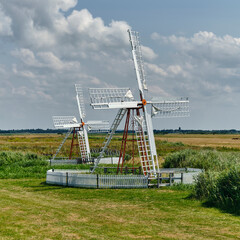 Historic pumping mills with archimedes screw in Ballum Enge traditional wind energy and rural landscape heritage in the countryside of Denmark © VeugerStock