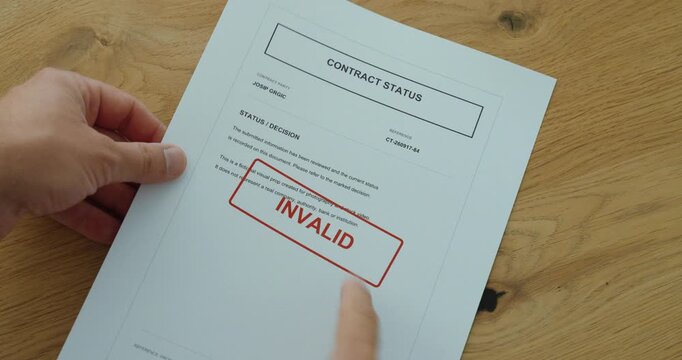 Person slides a contract status document into view from the side, revealing an invalid contract decision.