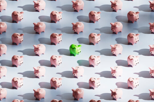 Green Piggy Bank Standing Out in Savings Pattern