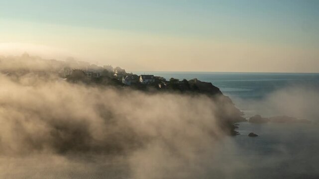 Timelapse of morning mist over Polruan headland, Fowey. At the mouth of Fowey Harbour, Cornwall UK. Static shot
