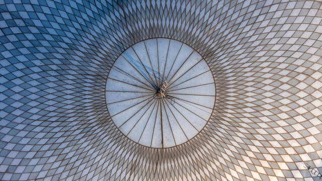 Aerial view of the intricate diamond-patterned roof structure of a large building, featuring a central circular hub and symmetrical grid design in Boyolali, Central Java, Indonesia.