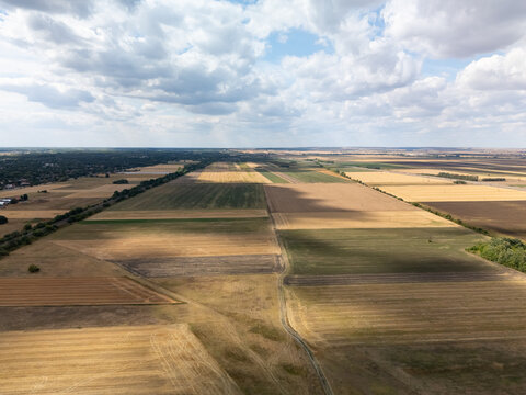 Aerial view of patchwork fields and dirt roads near Cegled, Hungary in summer