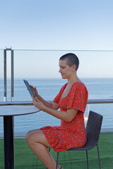 Woman using tablet outdoors with copy space © Pawel