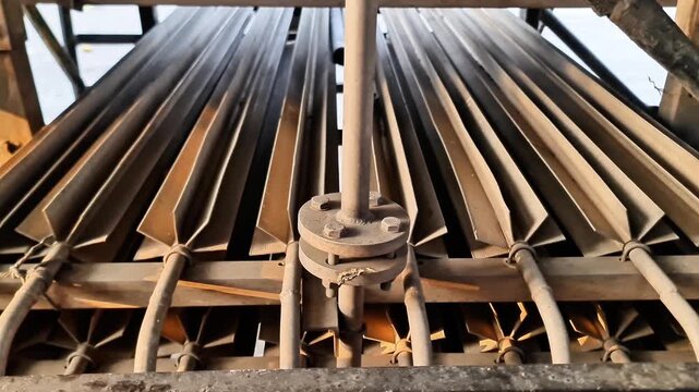 Close-up of Industrial Heat Exchanger with Parallel Longitudinal Finned Tubes and Metal Flange Connection
