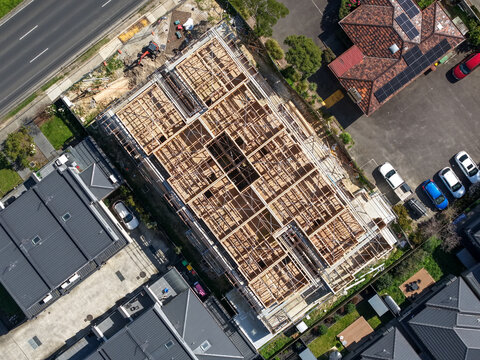 Melbourne, VIC, Australia - 18 September 2026: Aerial view of the Knox construction site featuring wooden framing and structural beams surrounded by residential houses and roads.