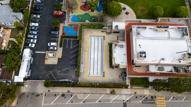View Park-Windsor Hills, California, United States - 16 September 2026: Aerial view of 54th Street Elementary School with its swimming pool, playground, and parking lot.
