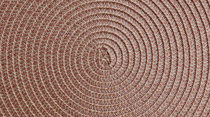 Fototapeta premium Pink beige woven placemat texture background with spiral pattern.