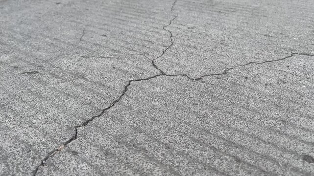 Close Up of Cracked Concrete Ground Surface Texture