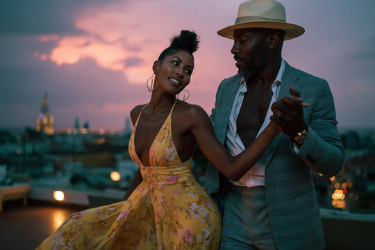 Romantic Couple Dancing on Rooftop at Sunset