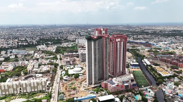 Wide cinematic panorama of SPR City, Perambur, capturing several towering residential buildings dominating the Chennai skyline, with ongoing construction and extensive low-rise urban development