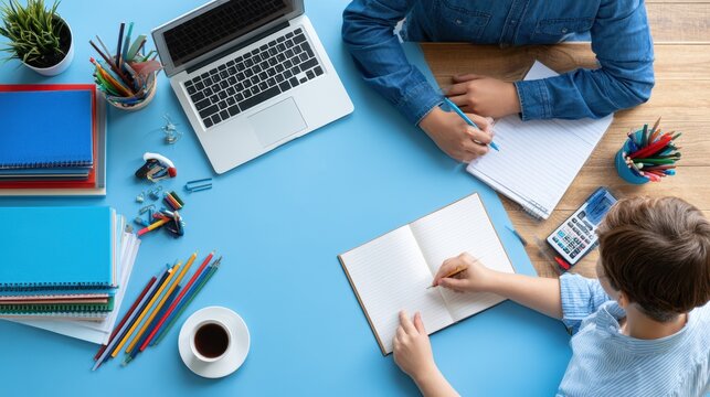 Overhead View of Child and Parent Doing Homework at Desk