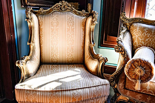 Elegant Baroque-style sofa with a hand-carved wooden frame and upholstery in beige and gold tones. Antiques, vintage furniture
