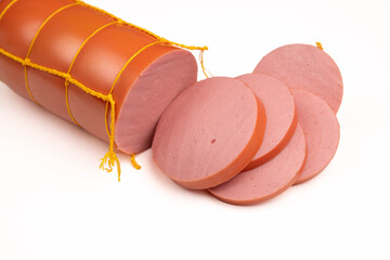 Sliced boiled sausage background closeup with fresh ham slices on white table, organic pork meat product cut piece texture, horizontal studio e-commerce copy space. © Inna Nikitina