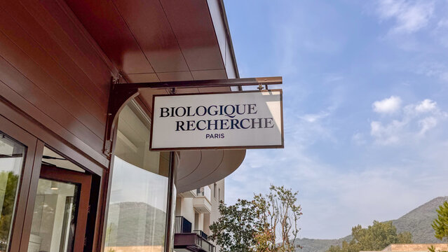 15.09.2026,Porto Montenegro.The branded Biologique Recherche Paris sign on a building facade at Porto Montenegro, Tivat, set against a backdrop of blue sky, greenery, and mountains.