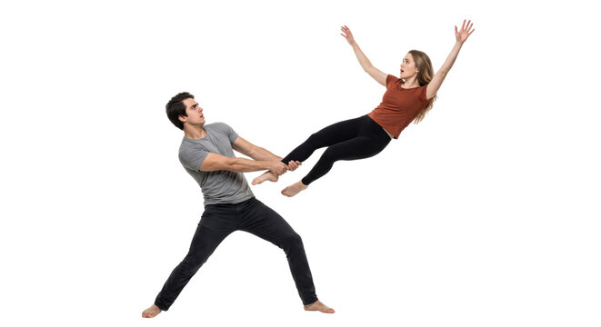 Man holding a floating woman by the ankle. Surreal levitation and weightless concept.