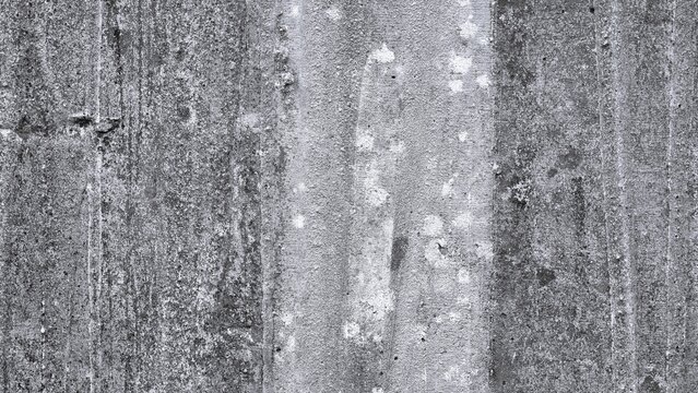 Weathered monochrome cement wall with rough granular texture and subtle vertical surface marks, creating an authentic industrial background with strong tactile detail.