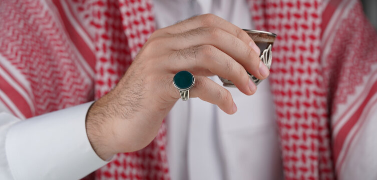 Arab man wearing traditional attire with ring 
