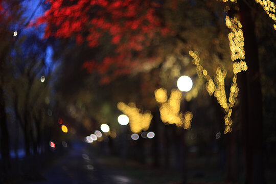 Evening in an autumn park, abstract blurred background, changing seasons in the city