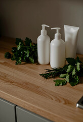 Obraz premium Organic skincare and natural beauty products, white cosmetic bottles with fresh herbs on wooden kitchen counter for sustainable wellness and spa routine