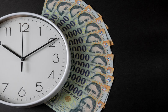 Time is money concept with Hungarian forint banknotes
